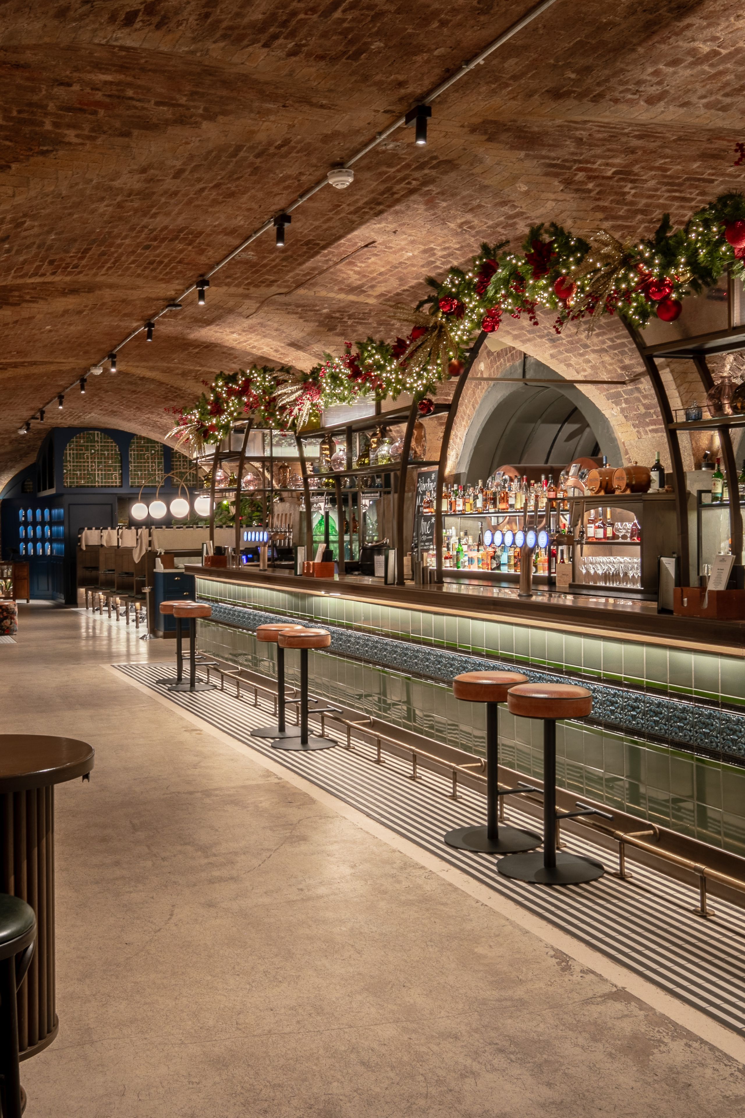 Bar with lights, Christmas wreaths and decorations on arches.