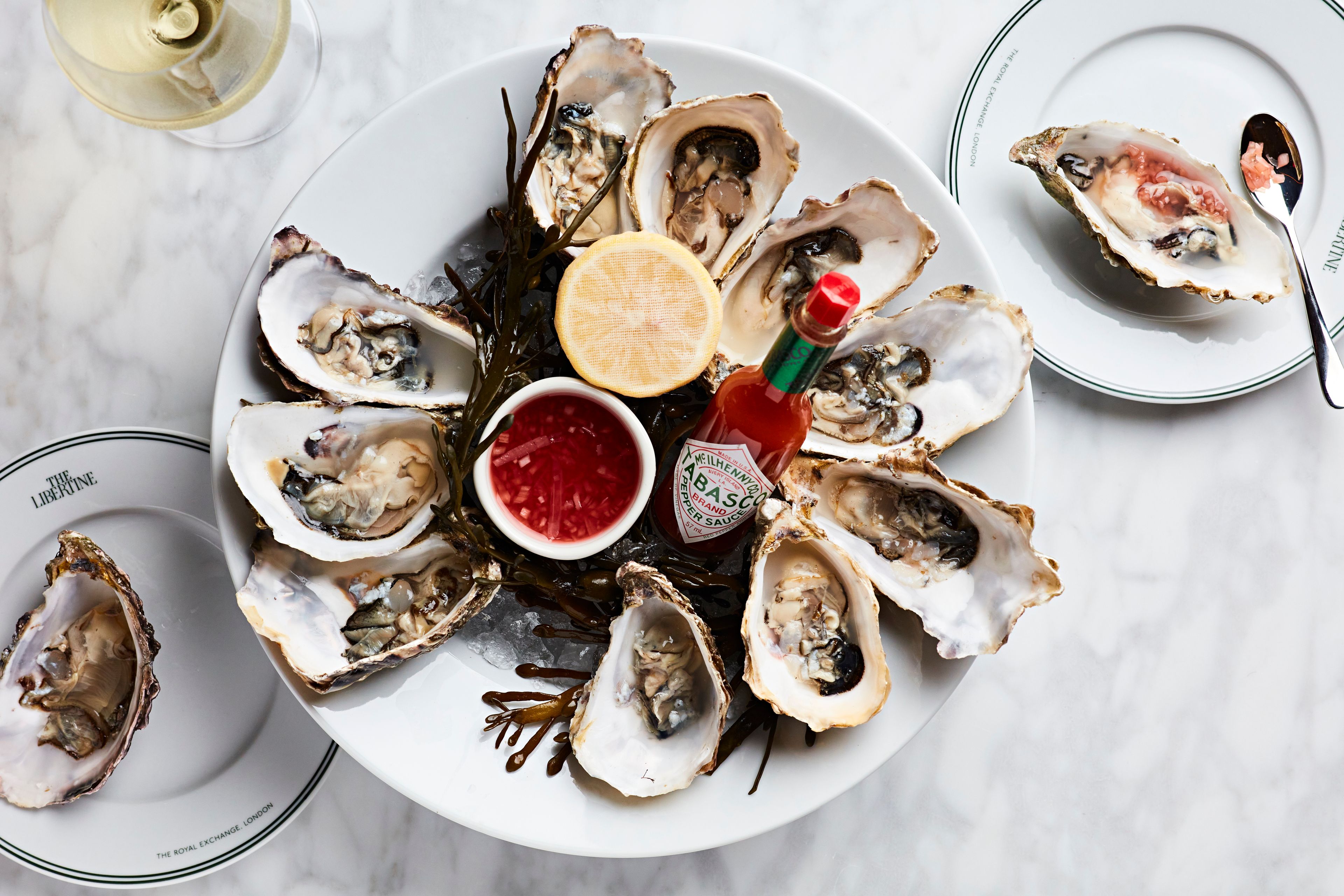 Oysters on ice with tabasco, lemon and a glass of wine.