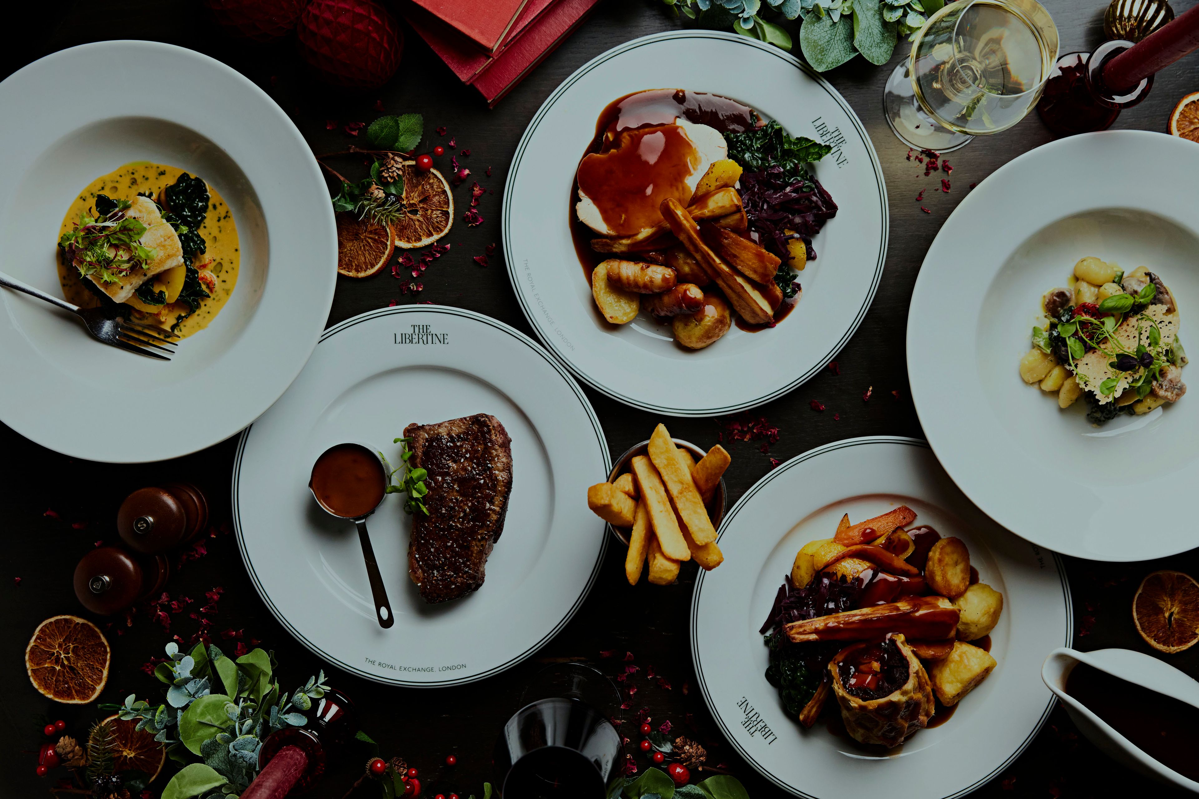 Christmas meal laid out on festive restaurant table with The Libertine logo visible.